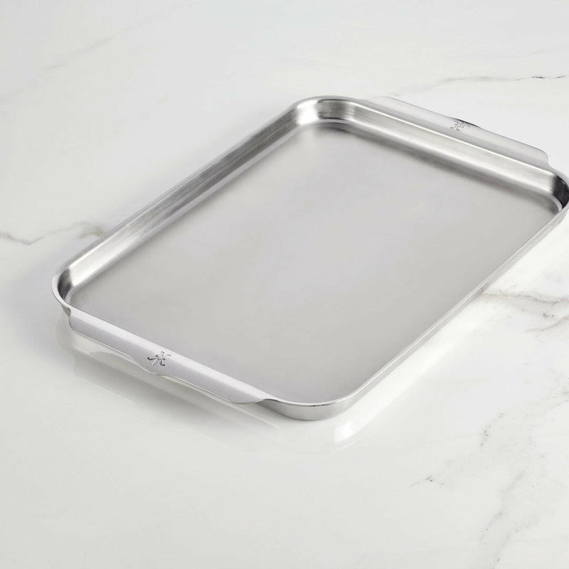 Hestan Provisions OvenBond Tri-Ply Bakeware - Medium Rack Only, featuring shallow sides and integrated handles, ideal for even baking and roasting on a light countertop.