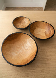 Creating Comfort Lab | Handmade Ukrainian Charred Wooden Salad Bowls, Small; three hand-carved nesting bowls with dark rims and rich grain patterns, ideal for serving or display.