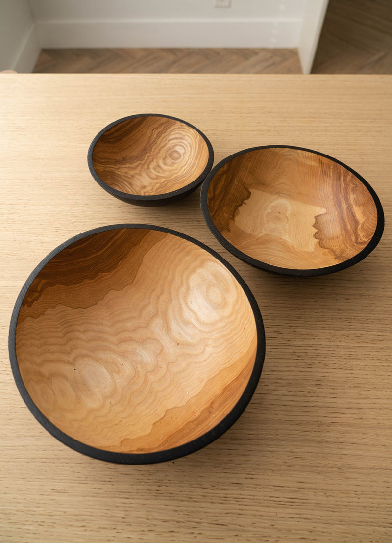 Creating Comfort Lab | Handmade Ukrainian Charred Wooden Salad Bowls, Large: Three hand-carved, nesting bowls with charred exteriors and natural wood grain interiors, ideal for serving and display.