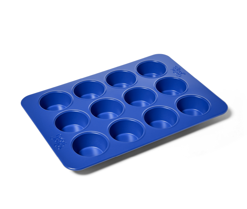 Great Jones | Stud Muffin - Blueberry pan with 12 nonstick, nontoxic cavities, ideal for muffins or cupcakes, ensures even heat distribution and easy cleanup.