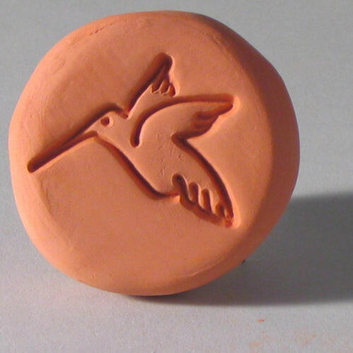 Close-up of a clay bird design on the Sugar Saver - Maple Leaf, used to keep brown sugar soft by soaking in water.