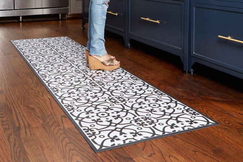 Liberty L Italian Vinyl Rug showcased in a kitchen setting, highlighting its black and white pattern and anti-slip design, ideal for indoor use.