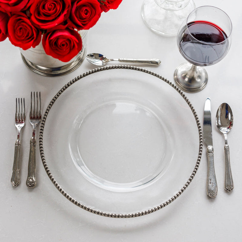 Tesoro Charger by Arte Italica & Crown Linen Designs, featuring mouth-blown glass and a pewter beaded rim, elegantly complements formal and casual dining settings.
