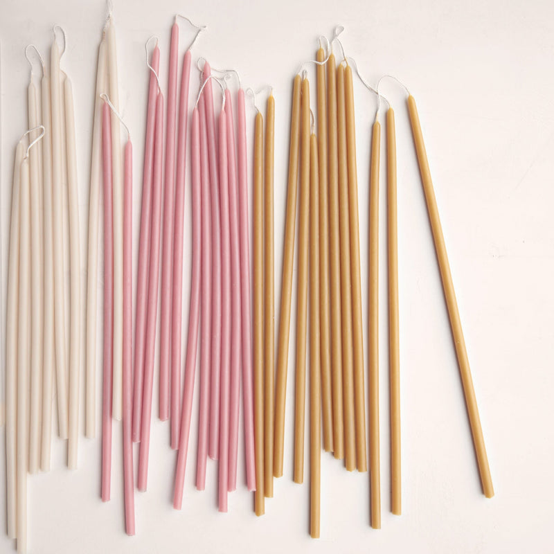 The Floral Society | Long Stem Beeswax Candles, Ochre, arranged in off-white, pale pink, and honey-yellow, showcasing their elongated, elegant form for versatile home ambiance.