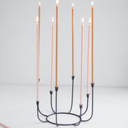 The Floral Society | Long Stem Beeswax Candles, Ochre, in a black iron candelabrum, ideal for intimate gatherings, showcasing minimalist elegance and smoke-free, natural beeswax craftsmanship.
