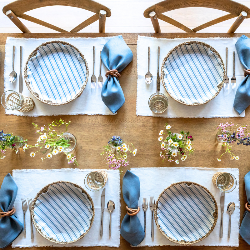 Seascape Blue Original Flat Plate Liners elegantly set on a table with silverware, reflecting the curated kitchen essentials from Athens Cooks.
