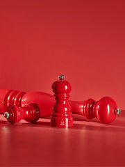 Peugeot | Paris Chef u'Select Passion Red Pepper Mills, 9 inches, displayed with one upright and two laid on sides, showcasing their glossy finish.