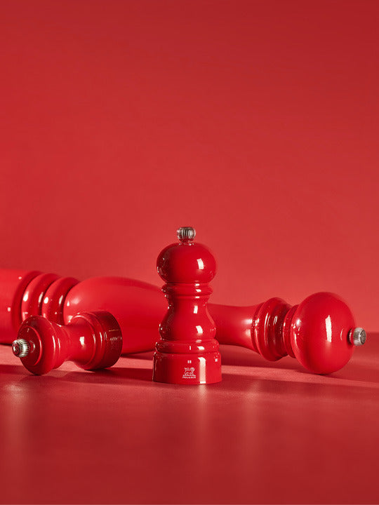 Peugeot | Paris Chef u'Select Passion Red Pepper Mill, 12 inches, featuring a classic silhouette and adjustable grind, elegantly displayed with two additional mills.