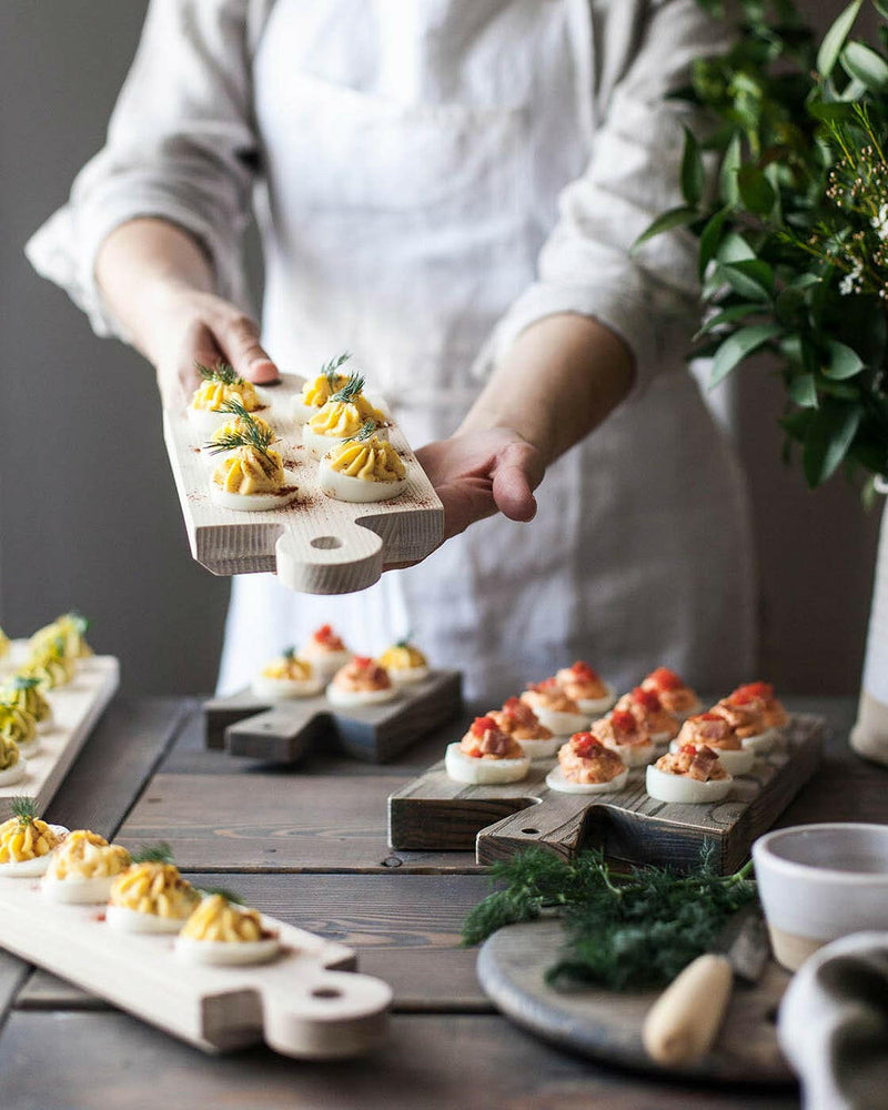 Farmhouse Pottery's Crafted Wooden Egg Boards - Cornish displayed with deviled eggs, showcasing rustic elegance and functionality for stylish egg presentation or storage.