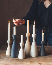Farmhouse Pottery's medium natural candlesticks, crafted from American ash with brass inserts, showcase classic elegance and modern design, perfect for any table setting.