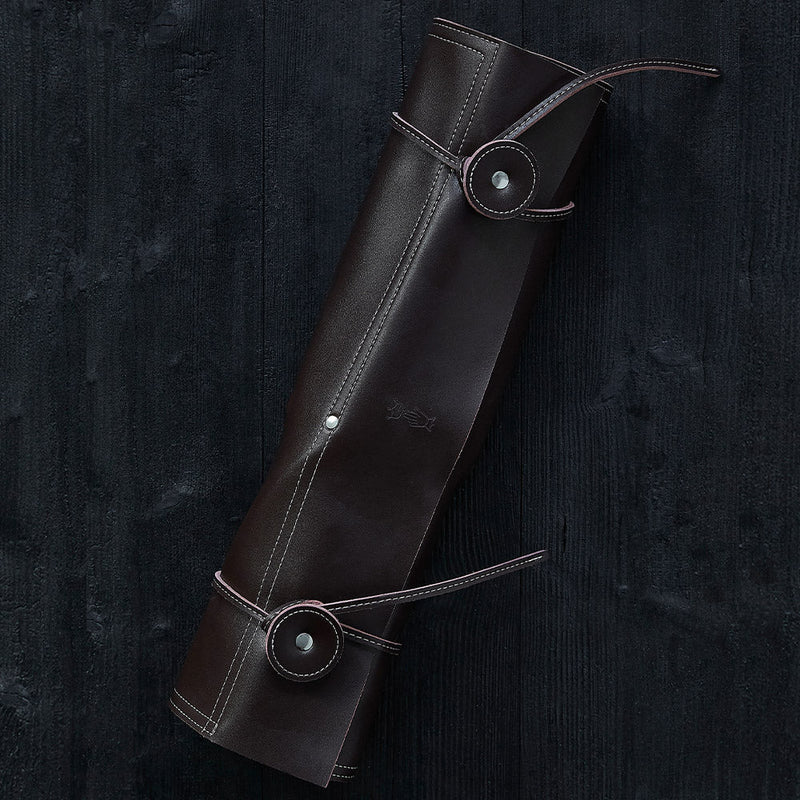 Opinel | 8 Slot Chef Knife Carrier, Synthetic Leather: A dark-brown leather roll-up pouch with straps, designed for securely holding up to eight chef knives.