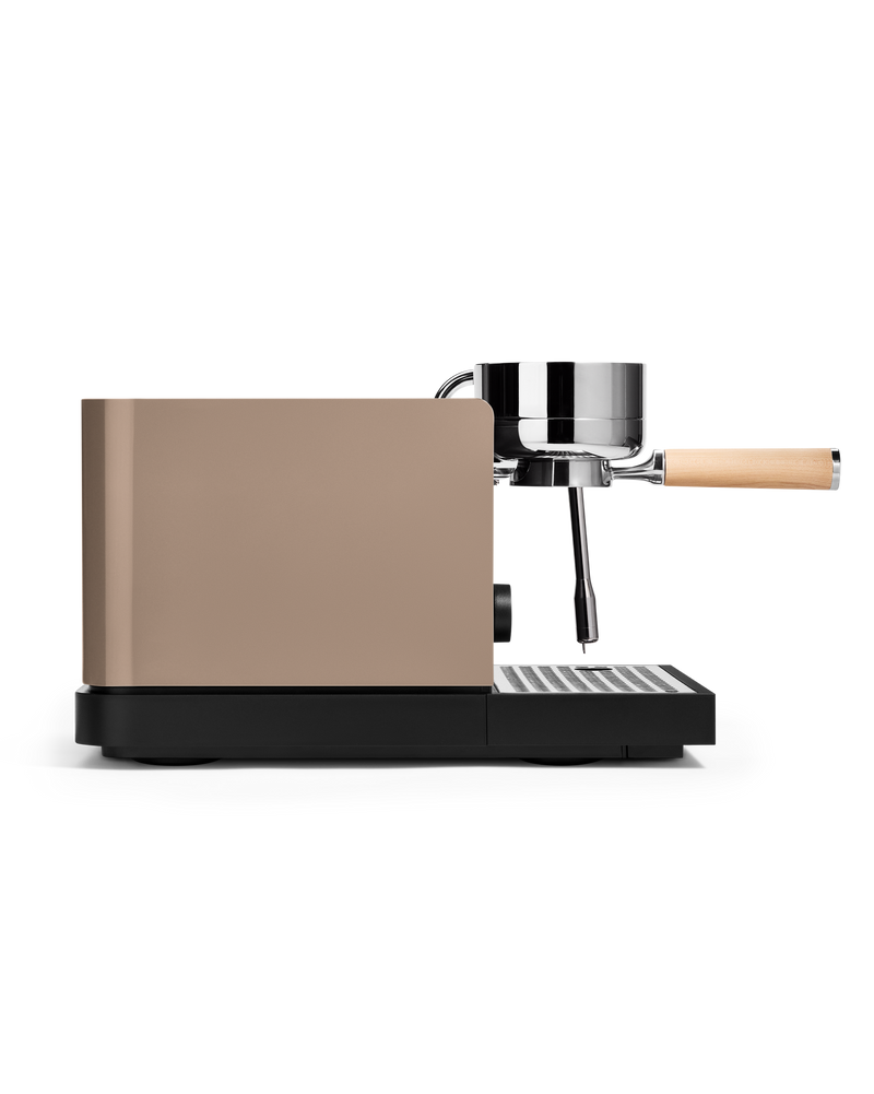 FELLOW | Espresso Series 1, a compact espresso machine featuring a matte-bronze housing, chrome brew head, wooden portafilter, and steaming wand for professional home use.