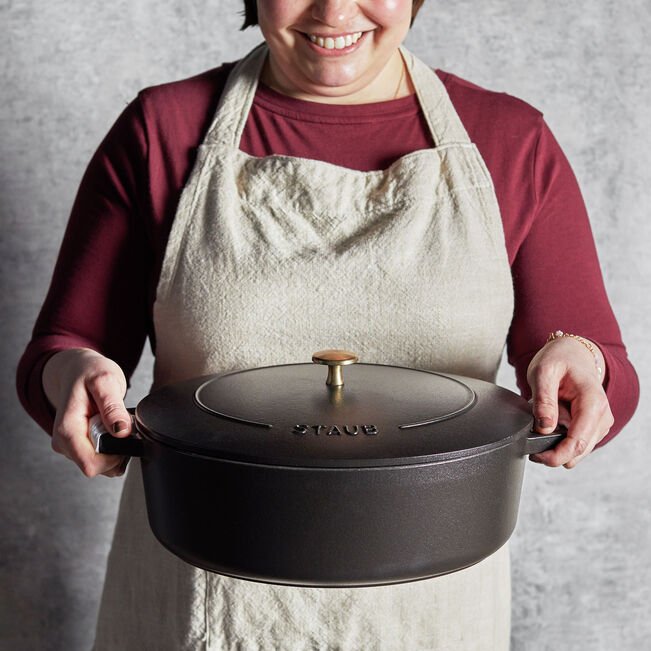 Staub | Wide Oval Dutch Oven - Graphite Grey, ideal for braising and baking, features a wide oval design for optimal searing and a self-basting lid for flavorful cooking.