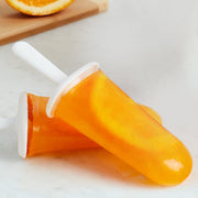 Zoku | Classic Pop Mold with orange popsicles displayed, showcasing its use for creating refreshing fruit-flavored treats.