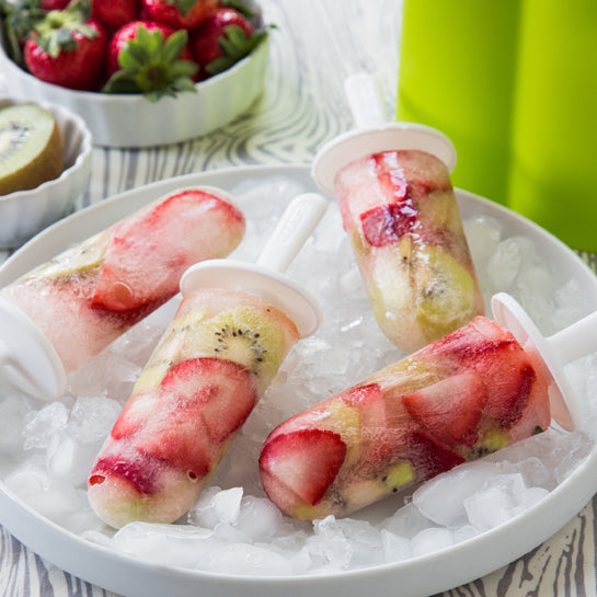 Zoku Classic Pop Mold featuring fruit-filled popsicles on ice, ideal for creating gourmet frozen treats at home.