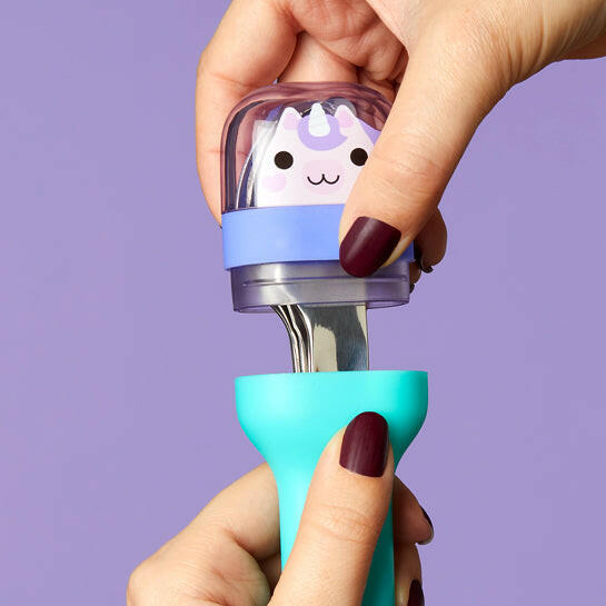 Hand holding Zoku | Kids Pocket Utensils - Shark, showcasing the compact, nested stainless steel spoon, fork, and knife set in a slim travel case.