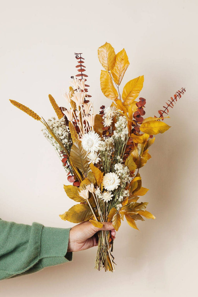 Idlewild Floral Co. - Golden Fall Market Bouquet, featuring dried leaves, eucalyptus, strawflowers, and grasses; a maintenance-free decorative piece for home ambiance.