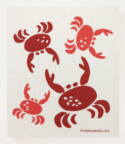 Three Bluebirds Swedish Dishcloth - Coral Crabs design, features red crab illustrations on a white background. Sustainable and absorbent, ideal for kitchen cleaning tasks.