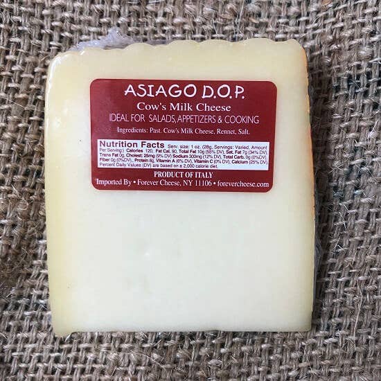 Nicola's Marketplace - Asiago D’Allevo DOP Mitica®: 7 ounces wedge, semi-firm cow’s milk cheese from Italy with red label detailing ingredients and nutritional facts. Ideal for culinary use.