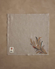 Coral & Tusk - Wheat Harvest Dinner Napkin featuring embroidered grasses and feathers in gold hues, showcasing a bountiful fall theme, ideal for an elegant table setting.