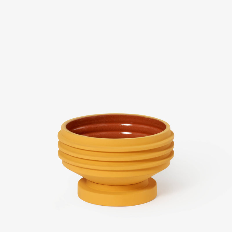 Areaware - Strata Plant Vessel: Yellow, a ceramic bowl with a round base and brown center, inspired by sculptural heritage and jewelry designs.