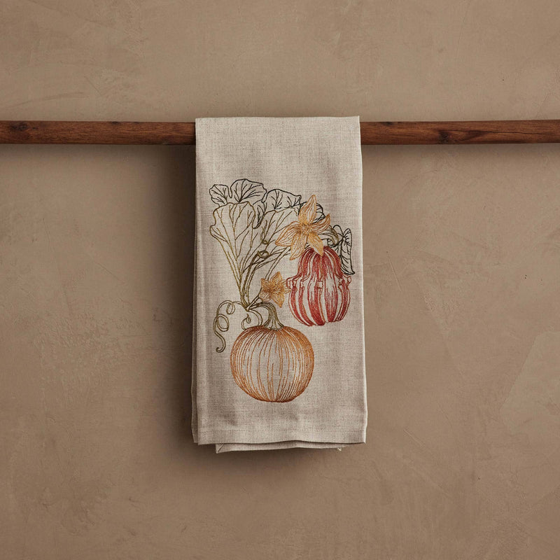 Coral & Tusk - Pumpkin Vine Tea Towel featuring embroidered pumpkins and blossoms, perfect for autumn kitchen decor. Measures 25 × 18 unfolded.