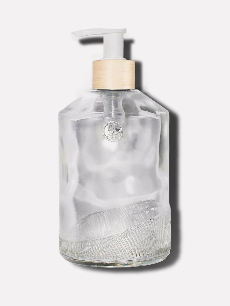 L'AVANT Collective - Empty Glass Bottle Clear, White Pump: A minimalist, durable 16 oz textured glass bottle with a white pump, ideal for elevating kitchen or bathroom counters.