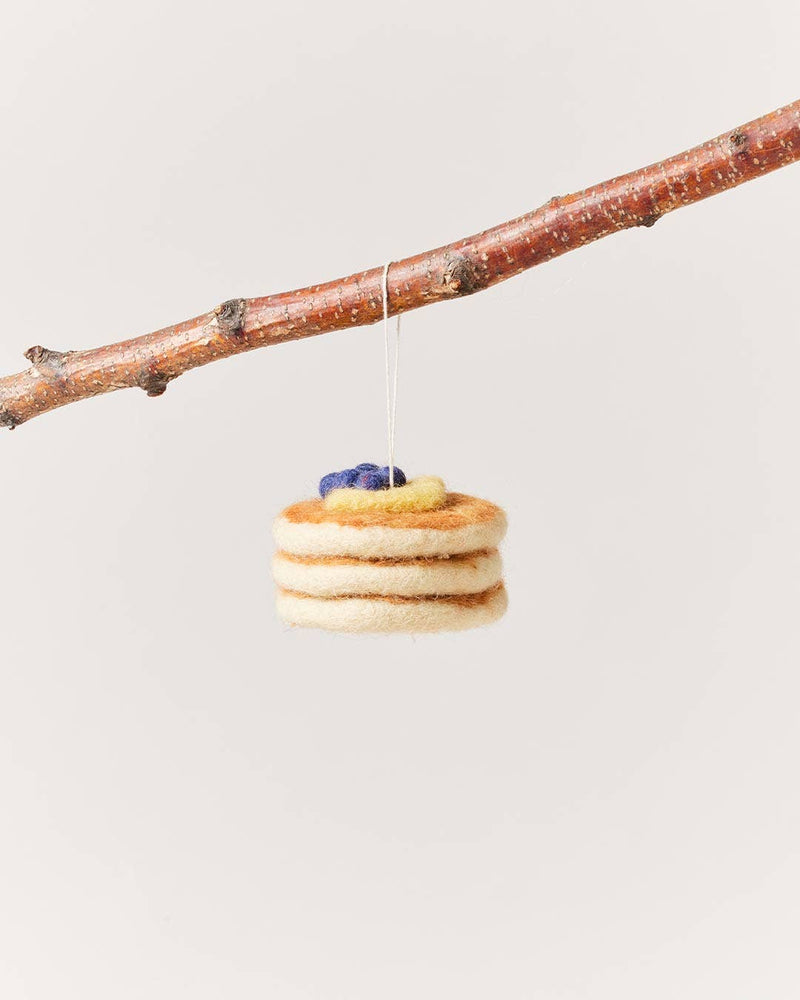 Farmhouse Pottery - Felted Breakfast Ornament: Waffle Stack hangs from a twig, featuring handcrafted wool felt layers resembling a waffle stack with butter and blueberries.
