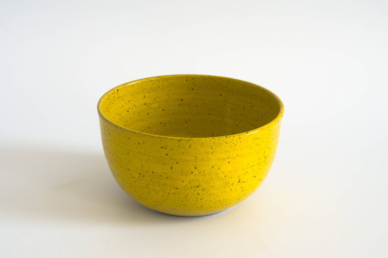 RachaelPots - Laura Bowl: Sage, a bright yellow, speckled ceramic bowl with a ribbed exterior for grip, perfect for versatile bowl meals.