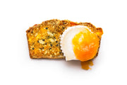 Rustic Bakery - Artisan Crisps - Citrus, Ginger & Thyme Box with seeded multigrain toast topped with a soft-poached egg, yolk oozing beautifully.