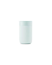 Reusable ceramic mug with lid, featuring a splash-resistant design and silicone grip, ideal for sustainable morning brews.