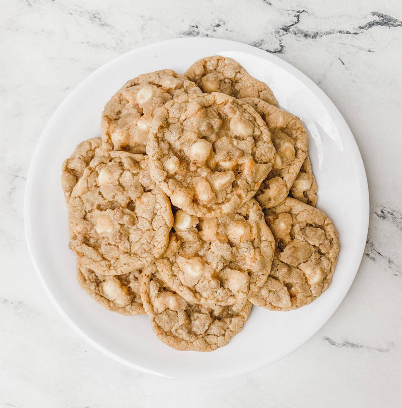 Southern Roots Sisters - White Chocolate Snickerdoodle Cookie Mix: a plate of round cookies with white chocolate chunks, showcasing a twist on classic snickerdoodles.