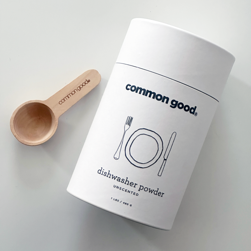 Common Good - Dishwasher Powder in a white container with a wooden spoon, designed for effective cleaning without harsh chemicals. Available for pre-order at Athens Cooks.