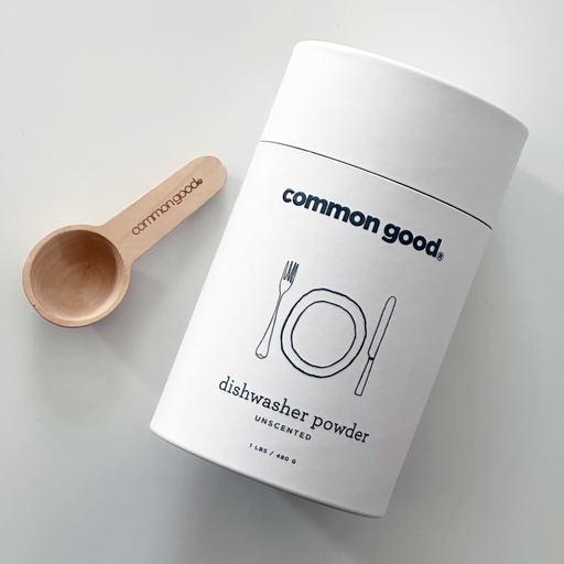 Common Good - Dishwasher Powder in a white container with a wooden spoon, designed for effective cleaning without harsh chemicals. Available for pre-order at Athens Cooks.