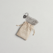 Smithey stainless steel chainmail scrubber with logo tag and drawstring bag