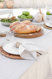 Set of 2 MagicLinen napkins in Woodrose on a table with bread and salad, demonstrating versatile table decor from Athens Cooks.