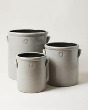 Farmhouse Pottery Agrarian Crocks in Toast, featuring hand-stamped volume on arched handle, showcasing natural iron flecking for texture.