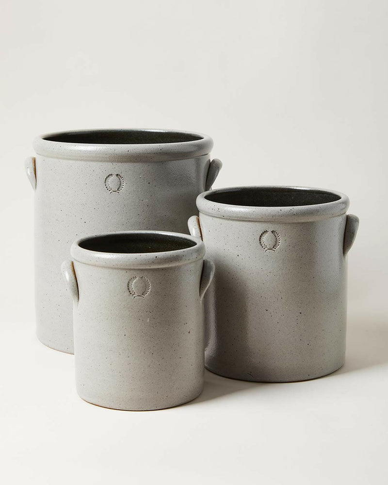 Farmhouse Pottery Agrarian Crocks in Toast, featuring hand-stamped volume on arched handle, showcasing natural iron flecking for texture.