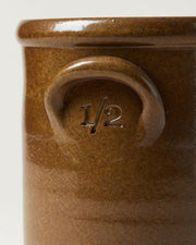 Farmhouse Pottery Agrarian Crocks in cool gray or warm brown glaze with charcoal interior, featuring hand-stamped volume inside the handle, showcasing artisanal craftsmanship.