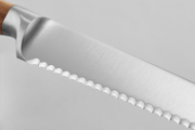 Wüsthof | Amici 5 Serrated Utility Knife, featuring a close-up view of its sharp, serrated blade, ideal for precise kitchen tasks.