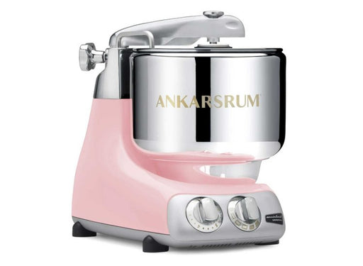 Ankarsrum Assistent Original® AKM6230 stand mixer in pastel pink with stainless steel bowl and control dials, ideal for mixing large dough batches.