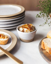 Farmhouse Pottery - Petite Silo Bowl: Single, displaying roasted garlic in a white-and-stoneware ramekin, surrounded by sliced bread, a butter knife, and fresh thyme.
