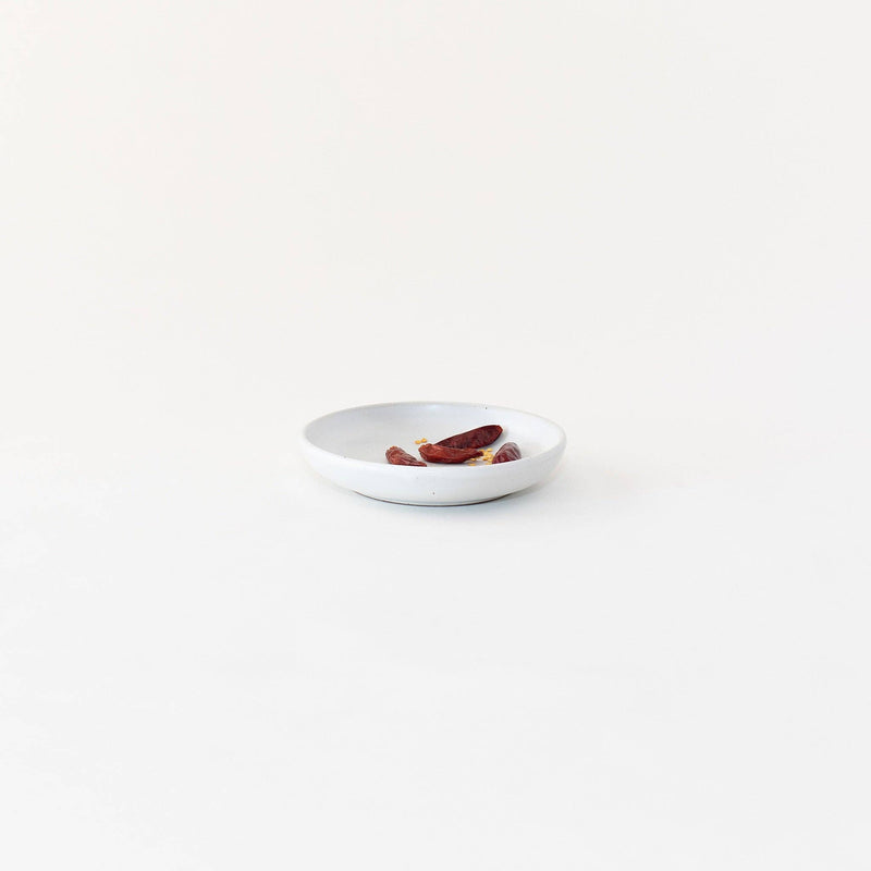 Sarah Kersten - Olive Dish: Basin Collection: Fig, a versatile small plate ideal for holding olives or bread, featured on a white plate with dried fruit and peppers.