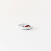 Sarah Kersten - Olive Dish: Basin Collection: Straw, a versatile, small white plate ideal for serving appetizers or sides, displayed with food.
