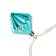 MoMA | LED String Lights Diamond featuring a single turquoise-blue, faceted bulb with a geometric pattern, hanging from a clear cord, ideal for versatile, elegant decor.