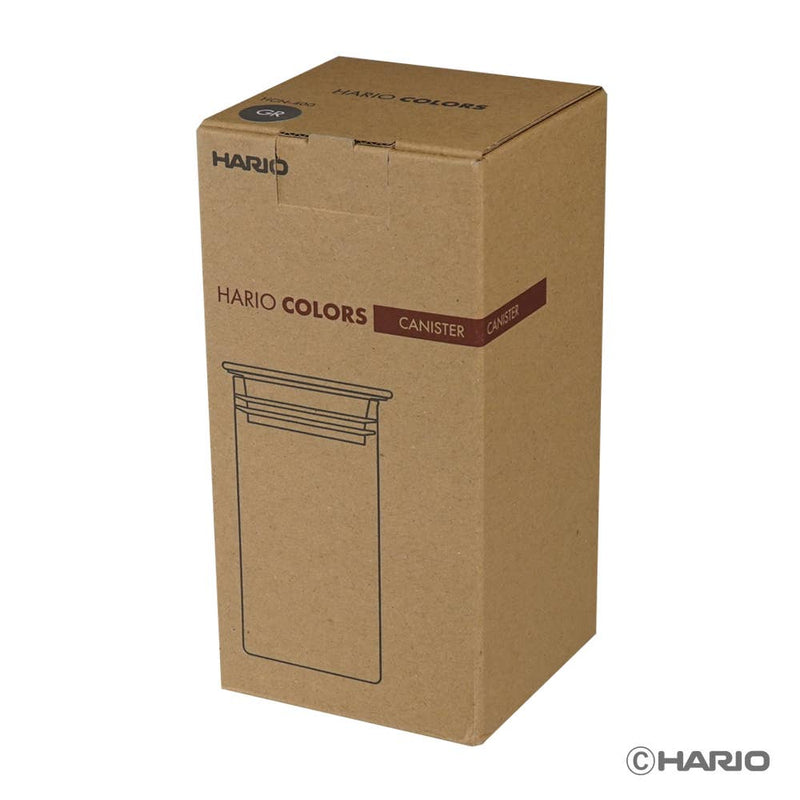 HARIO USA - HARIO Colors Glass Canister, 400ml: Amber, shown in its brown cardboard packaging, ideal for storing coffee beans or tea with a secure silicone seal.