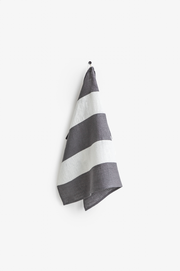 Striped Linen Tea Towel by MagicLinen hanging on a hook, showcasing its loop for easy storage; part of a zero-waste initiative, ideal for eco-conscious kitchens.