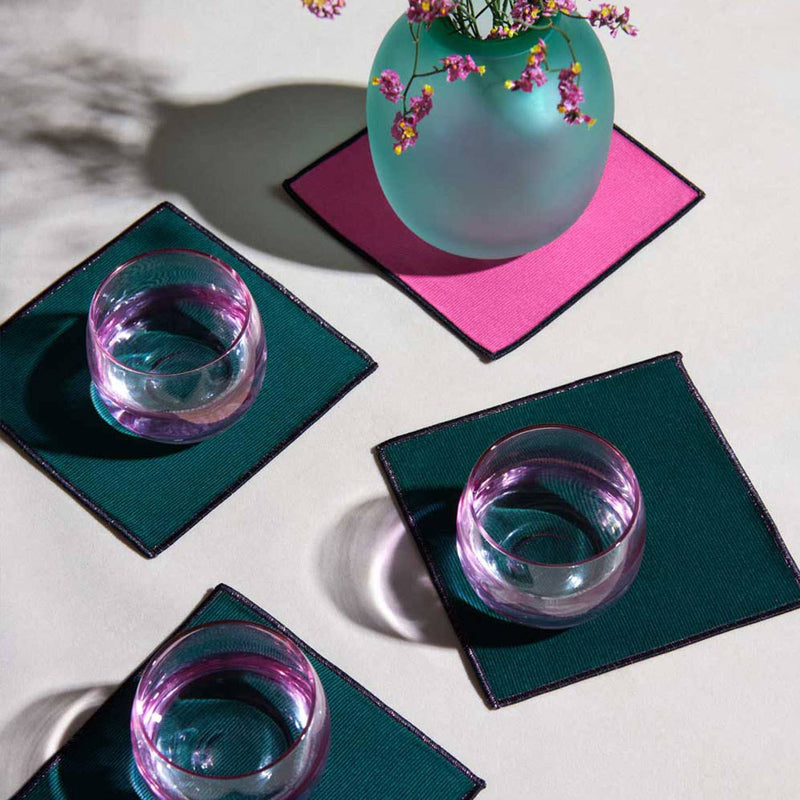 ATELIER SAUCIER - Bird of Paradise Cocktail Napkins | Set of 4, showcasing vibrant coasters with a teal vase and blossoms, echoing tropical elegance, ideal for sophisticated kitchen settings.