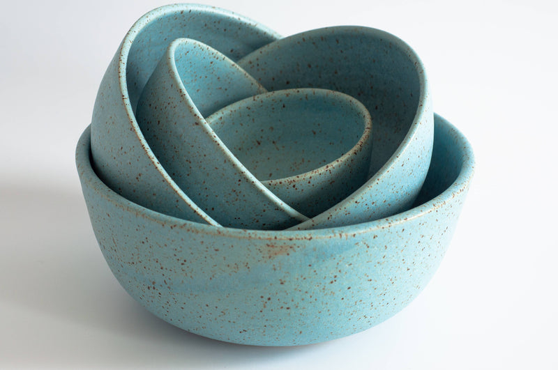 Nestled set of turquoise-blue, speckled ceramic bowls, showcasing the RachaelPots - Laura Bowl: Sage, ideal for diverse meals with its tall, ribbed design.