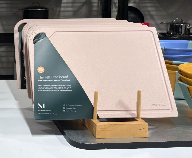 Material - The MK Free Board: Ocean displayed in a wooden rack, featuring a plant-based, nonporous, dishwasher-safe design with a juice groove, ideal for safe, smart chopping.